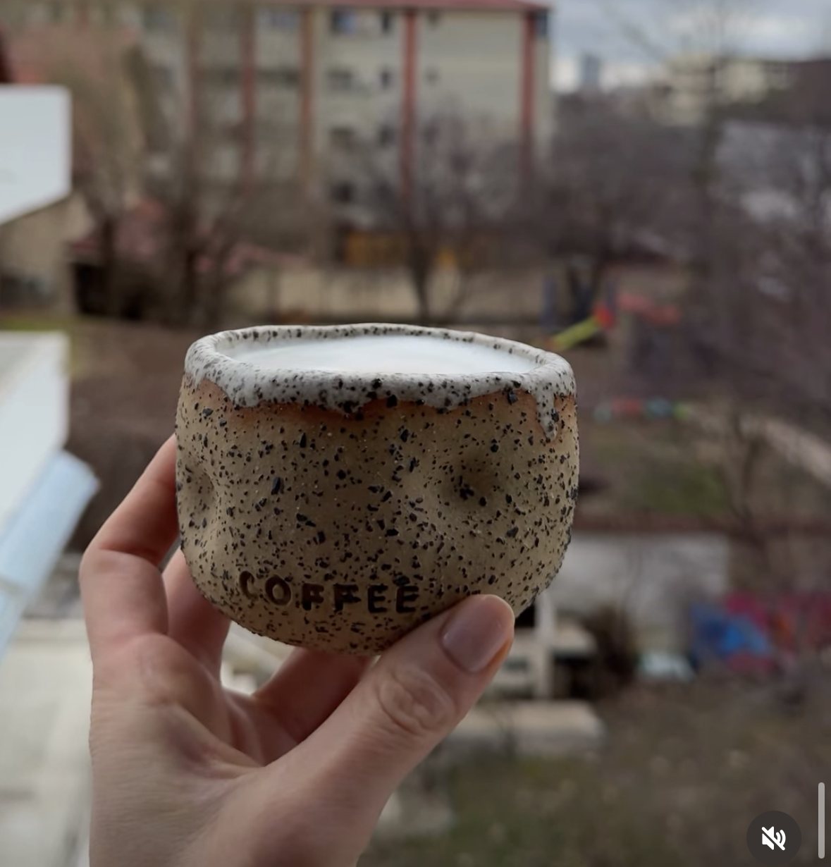 Coffee speckled cup held up